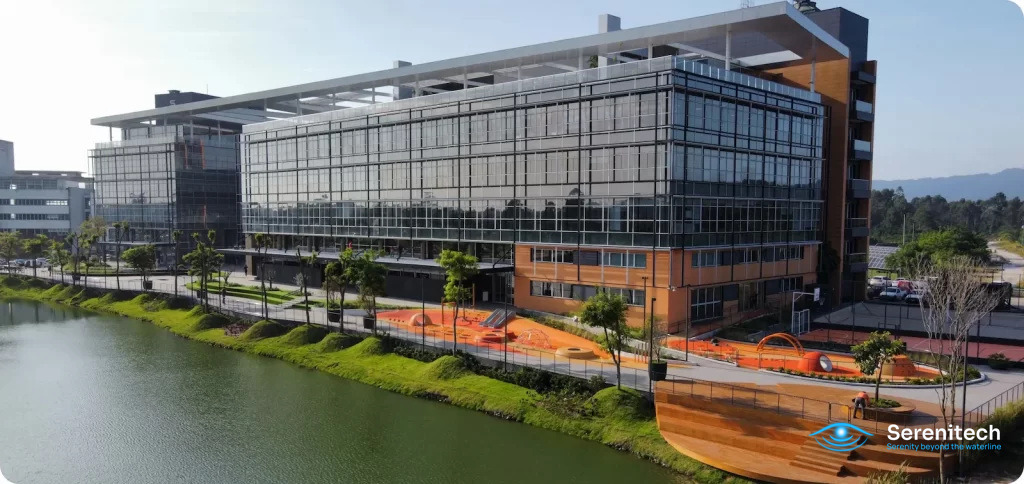 Aerial view of the glass office building of the Brazil headquarters in Sapiens Parque, Florianópolis, beside a lake
